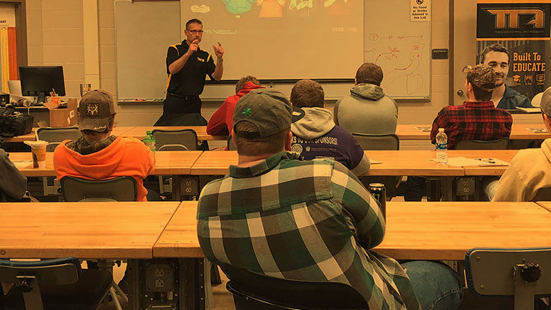 Teacher at automotive facility teaching students
