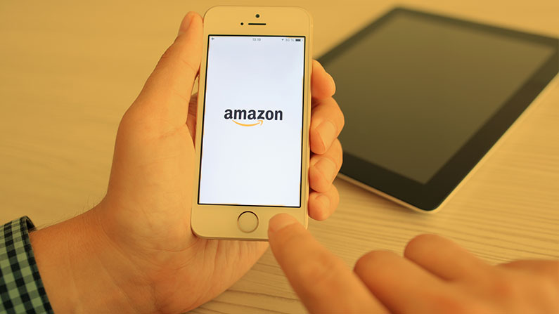 Buyer uses mobile phone to browse Amazon
