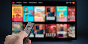 Tv online. Television streaming video. Male hand holding TV remote control. Multimedia streaming concept. VoD content provider. Video service with internet streaming multimedia shows, series.