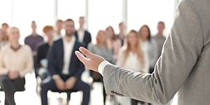 image of a speaker giving a lecture at a business seminar